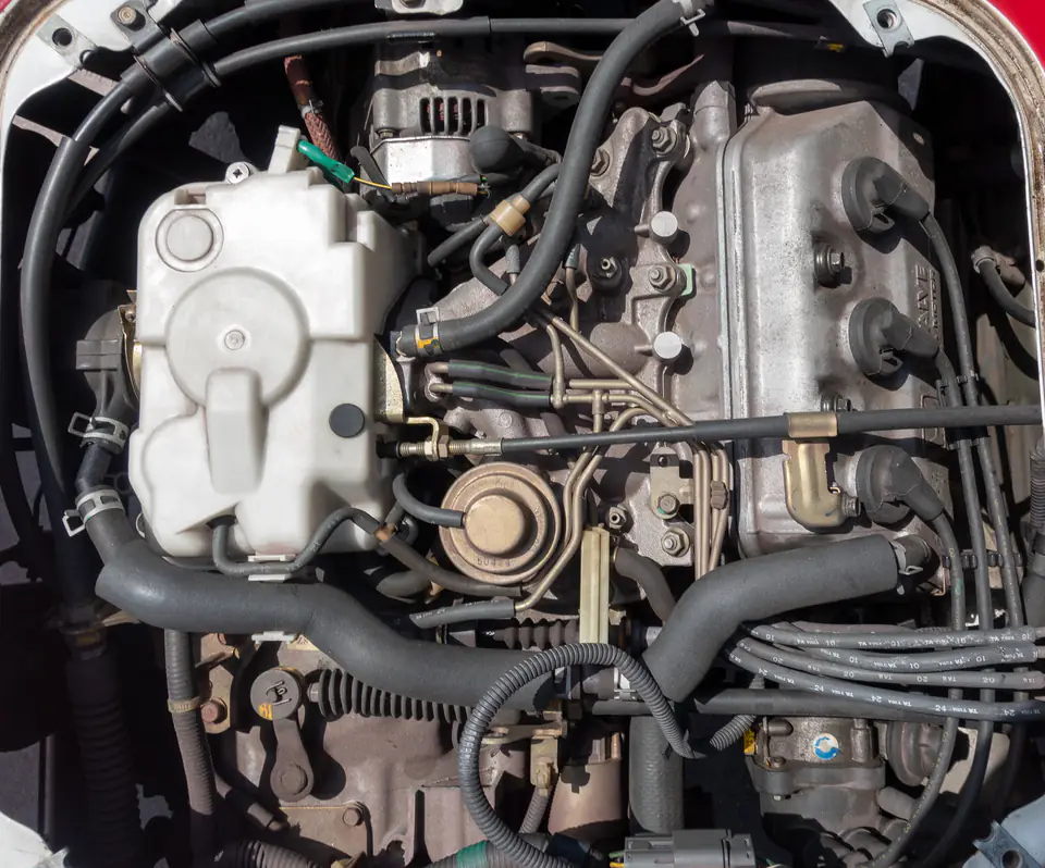 Honda Acty E07A 660cc three-cylinder engine with the bed access panel removed