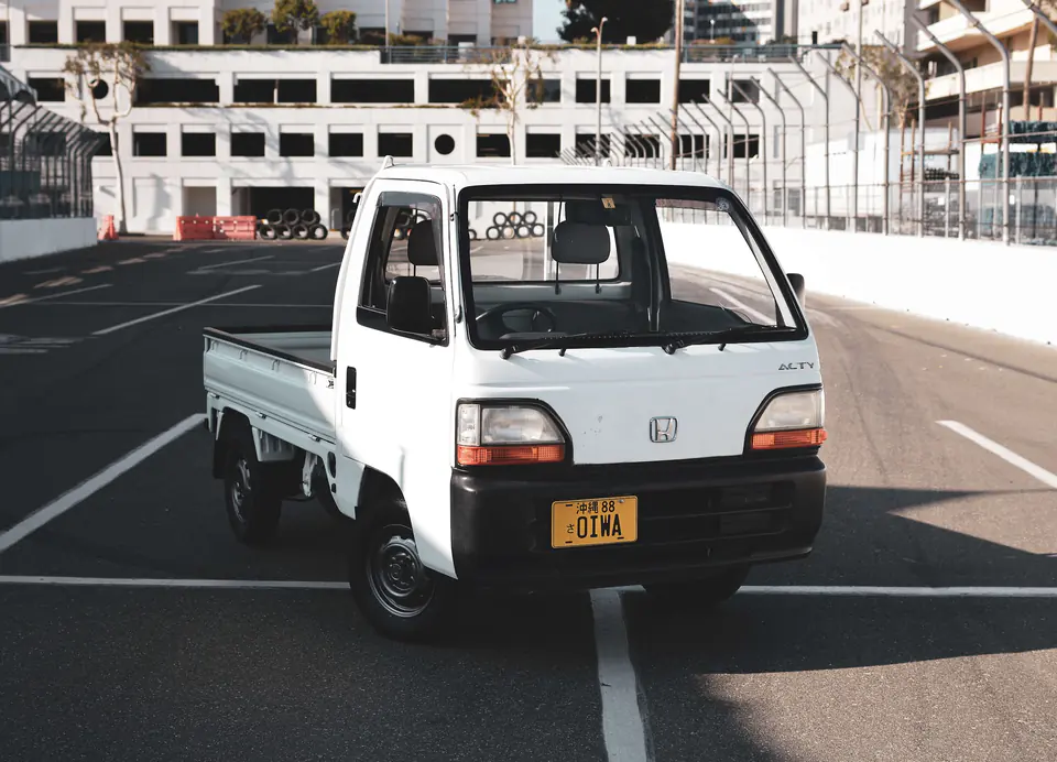 White Honda Acty Kei Truck on the Long Beach street circuit lined with tire barriers