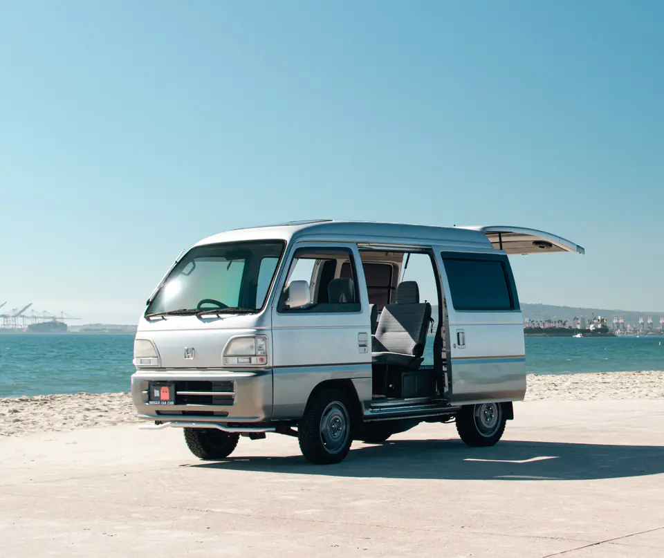 Silver Honda Acty Street Kei Van on the beach with its sliding side door and rear hatch open
