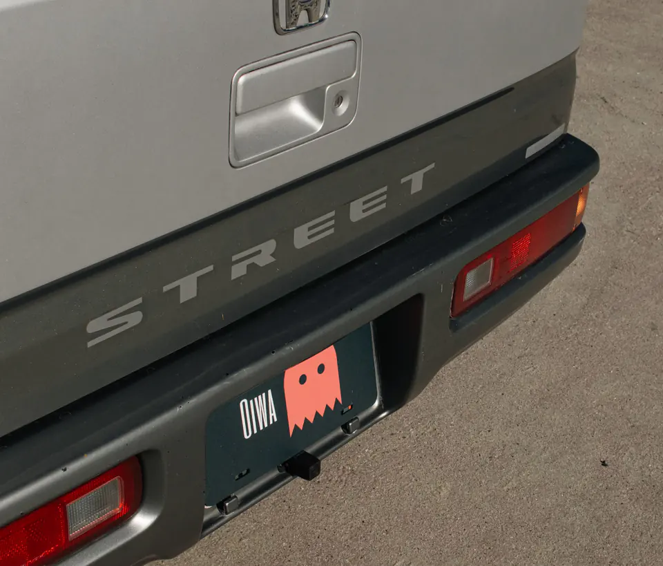Street badge on the rear of a silver Honda Acty Kei Van