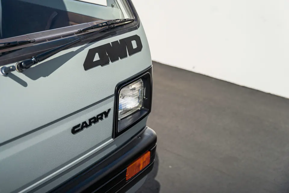 4WD and Carry decals on the cab of a vintage Suzuki Carry Kei Truck